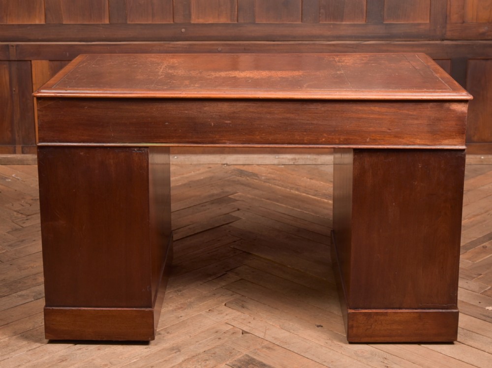 An Edwardian mahogany pedestal desk with nine drawers, brass ring handles, and a leather-inset writing surface. View XVII