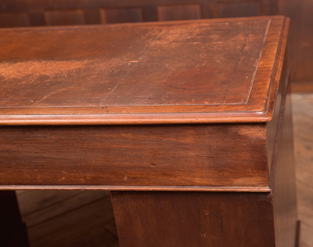 An Edwardian mahogany pedestal desk with nine drawers, brass ring handles, and a leather-inset writing surface. View XVIII