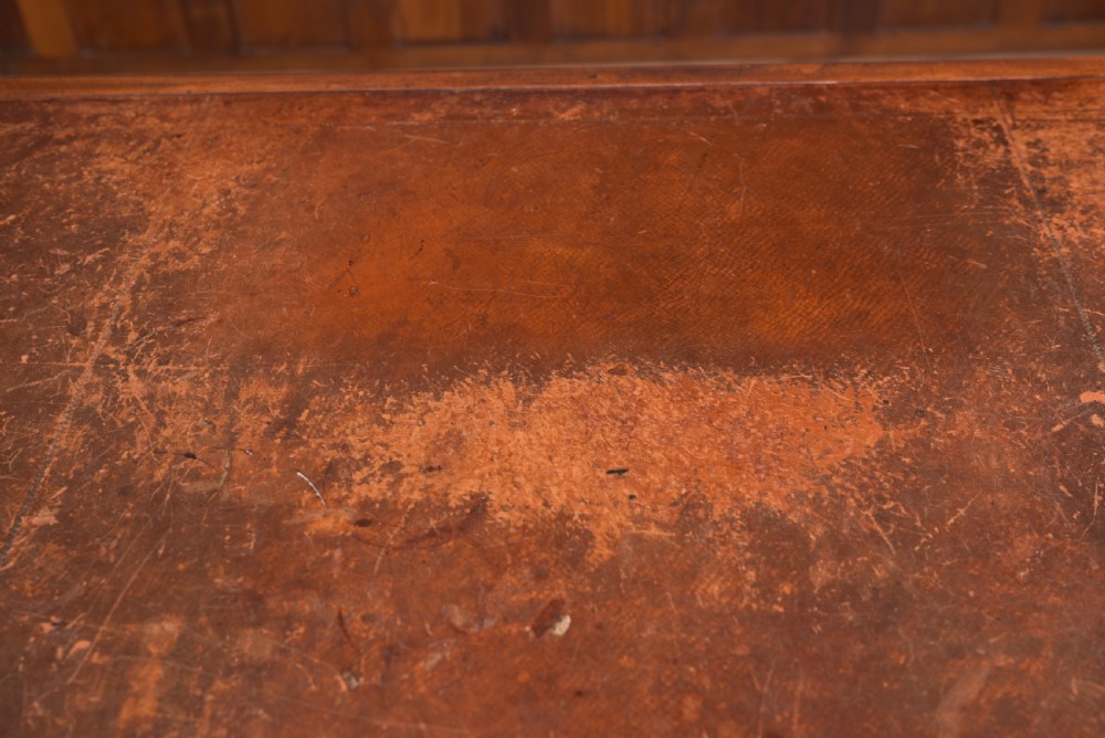 An Edwardian mahogany pedestal desk with nine drawers, brass ring handles, and a leather-inset writing surface. View XIX