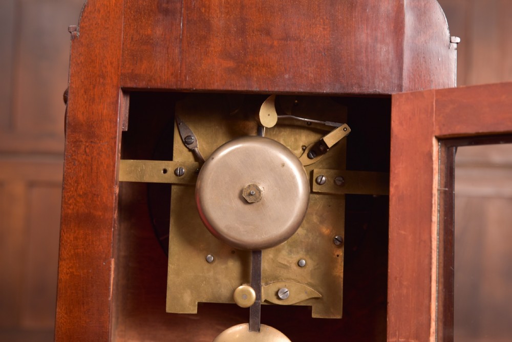 An antique mahogany bracket clock featuring Gothic spire finials, a carved foliage crest, and a cream dial signed Christie Perth set within a brass bezel. View VI
