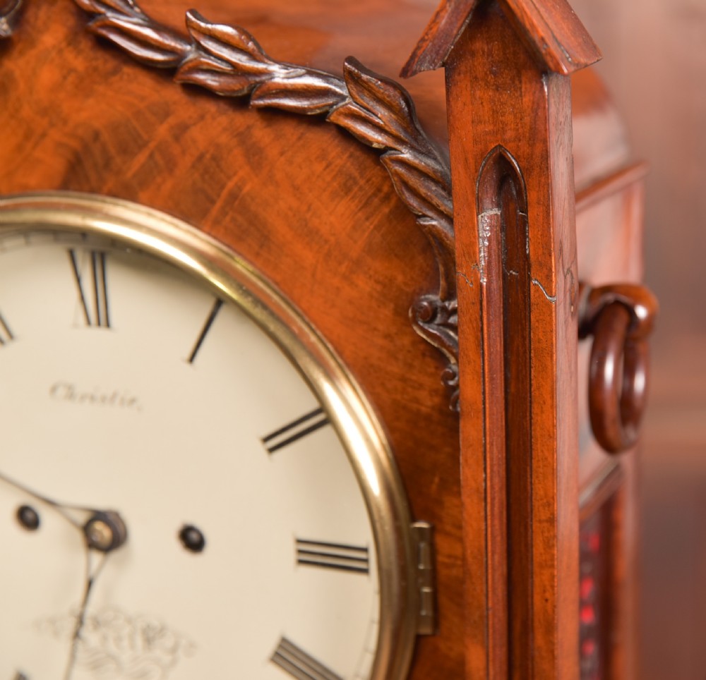 An antique mahogany bracket clock featuring Gothic spire finials, a carved foliage crest, and a cream dial signed Christie Perth set within a brass bezel. View IX