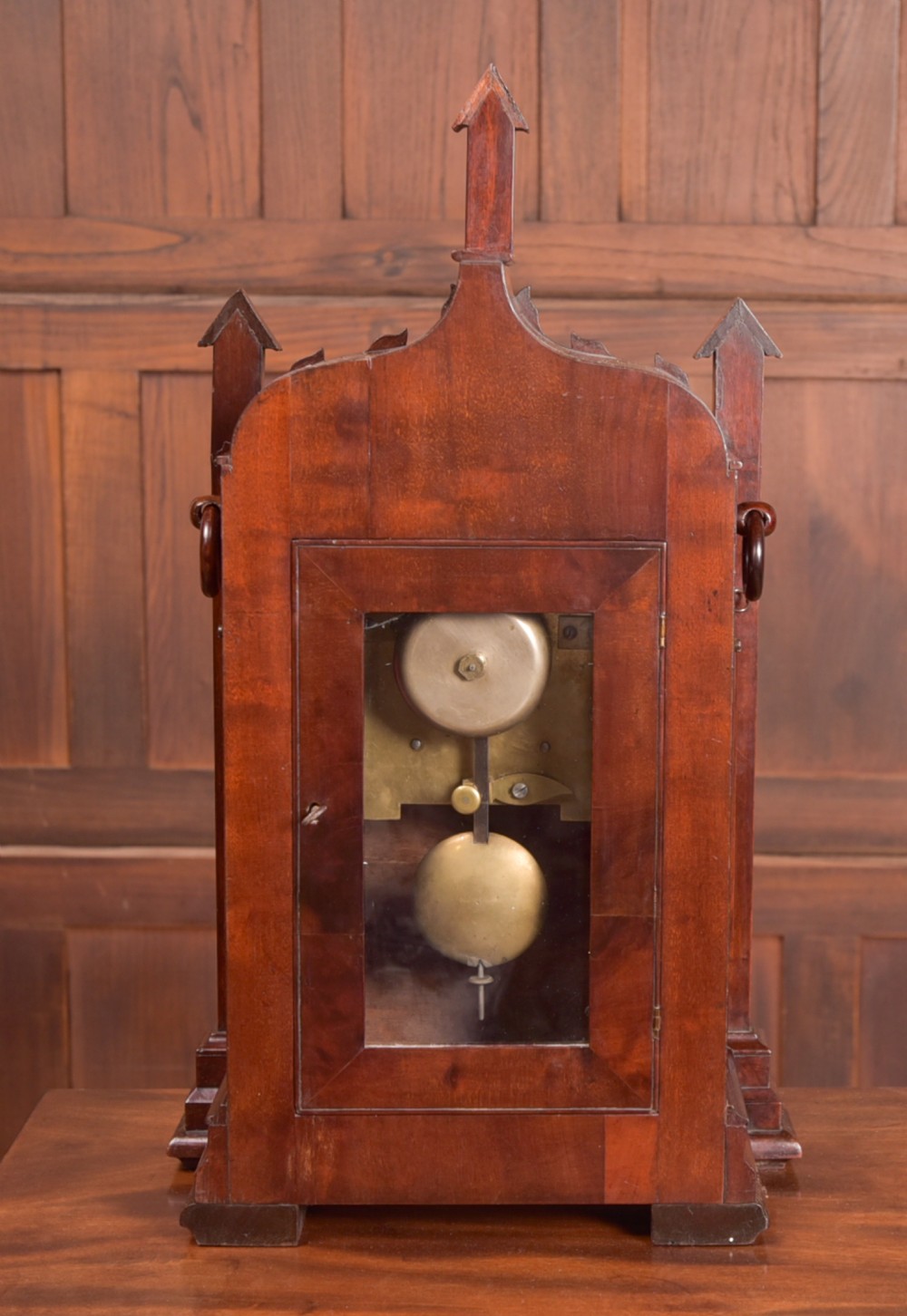 An antique mahogany bracket clock featuring Gothic spire finials, a carved foliage crest, and a cream dial signed Christie Perth set within a brass bezel. View XI