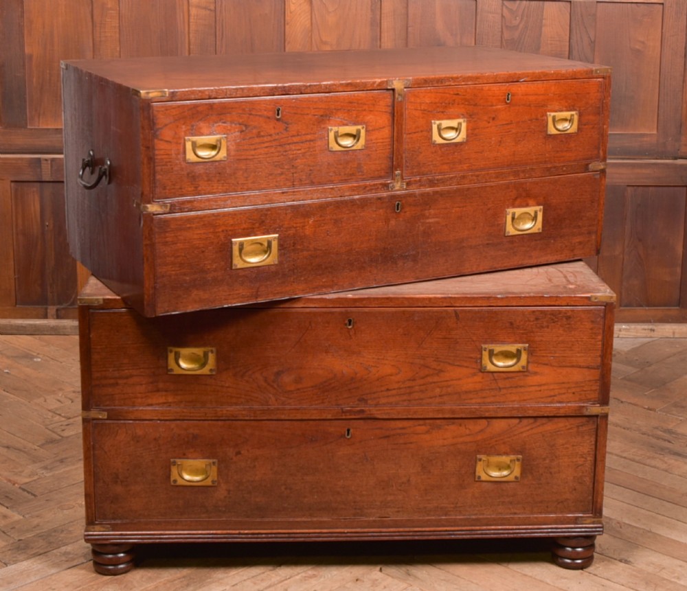 A nineteenth-century teak military campaign chest of drawers with flush brass handles, corner brackets, and turned feet. View XVI