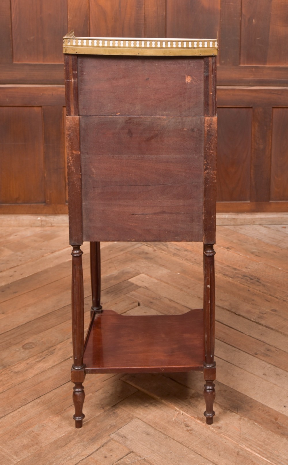 A French mahogany roll-top pot cupboard with a marble top, brass gallery, drawers, slatted tambour front, and turned legs. View VIII