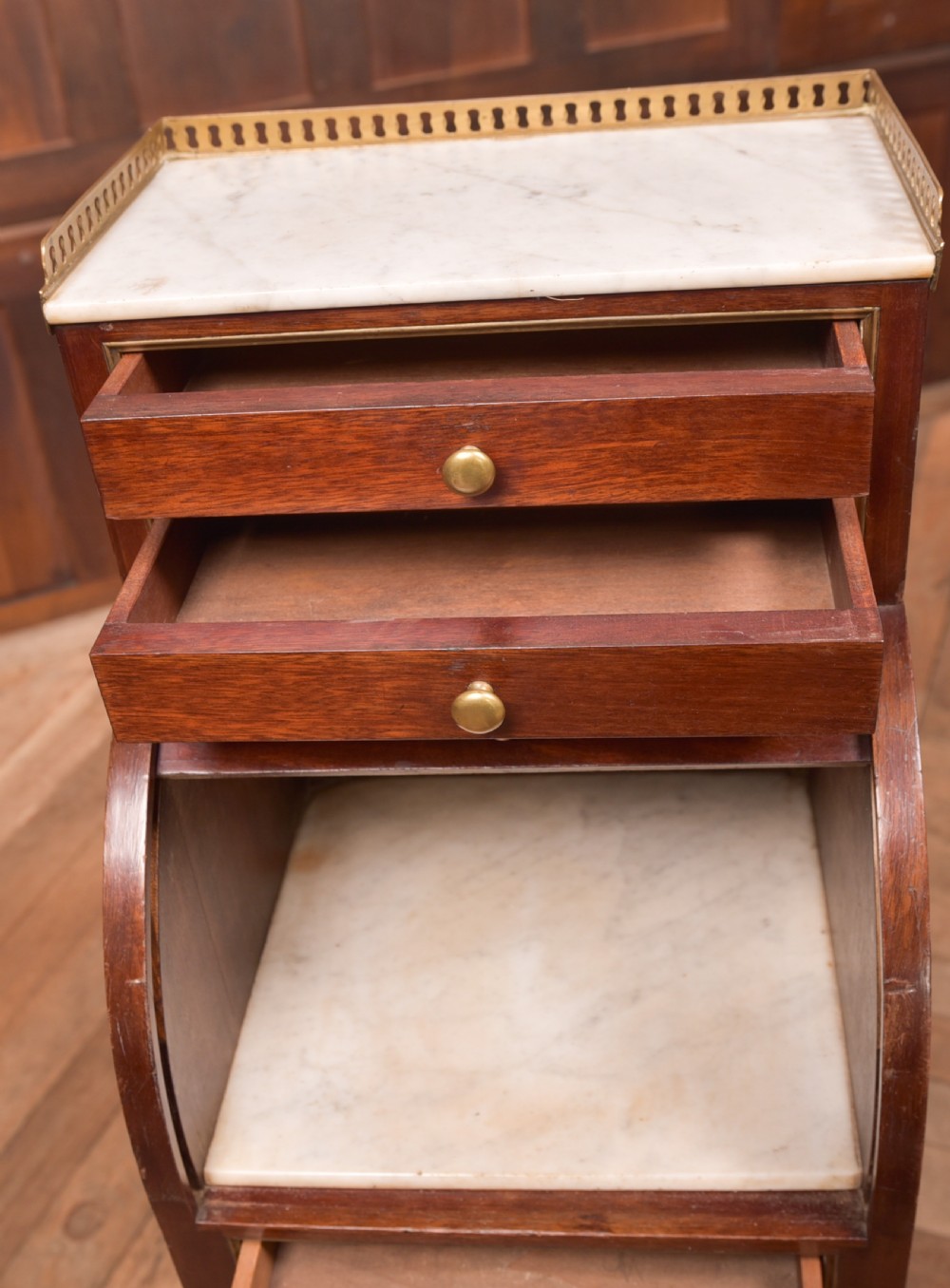 A French mahogany roll-top pot cupboard with a marble top, brass gallery, drawers, slatted tambour front, and turned legs. View X