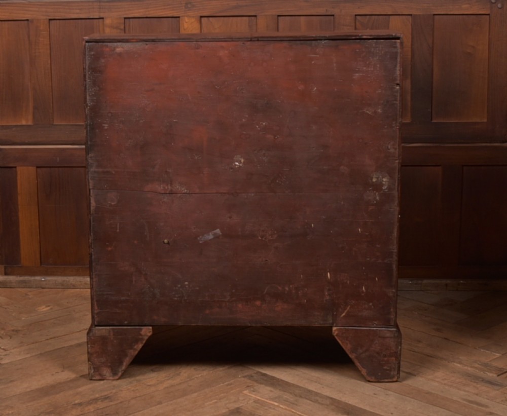 A Georgian mahogany writing bureau featuring a sloped fall-front writing flap above four graduated drawers with brass swan-neck handles and bracket feet. View XII