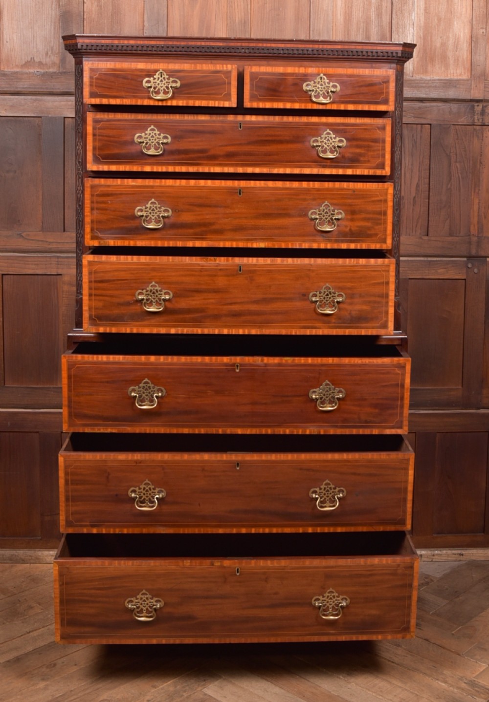 A tall Georgian mahogany chest on chest featuring inlaid drawer borders, brass handles, dentil cornice detail, and bracket feet. View XIII