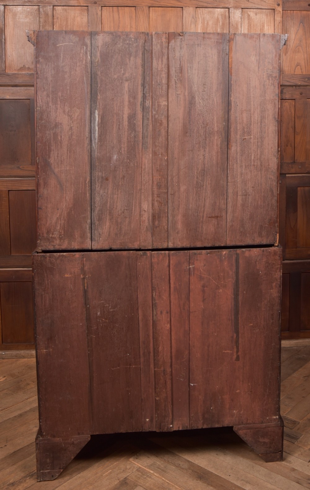 A tall Georgian mahogany chest on chest featuring inlaid drawer borders, brass handles, dentil cornice detail, and bracket feet. View XV