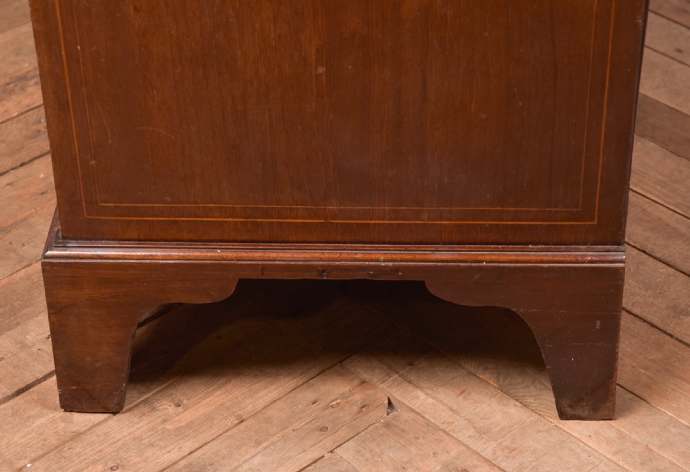 A tall Georgian mahogany chest on chest featuring inlaid drawer borders, brass handles, dentil cornice detail, and bracket feet. View XVIII