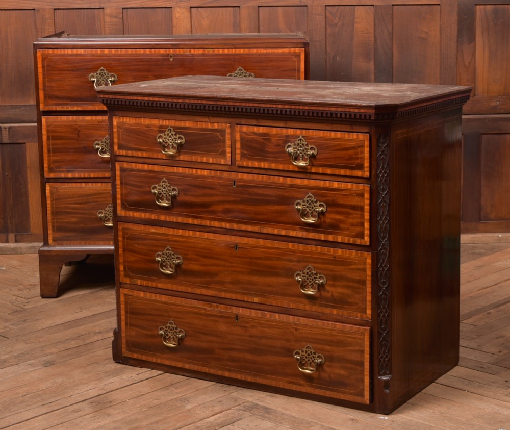 A tall Georgian mahogany chest on chest featuring inlaid drawer borders, brass handles, dentil cornice detail, and bracket feet. View XIX