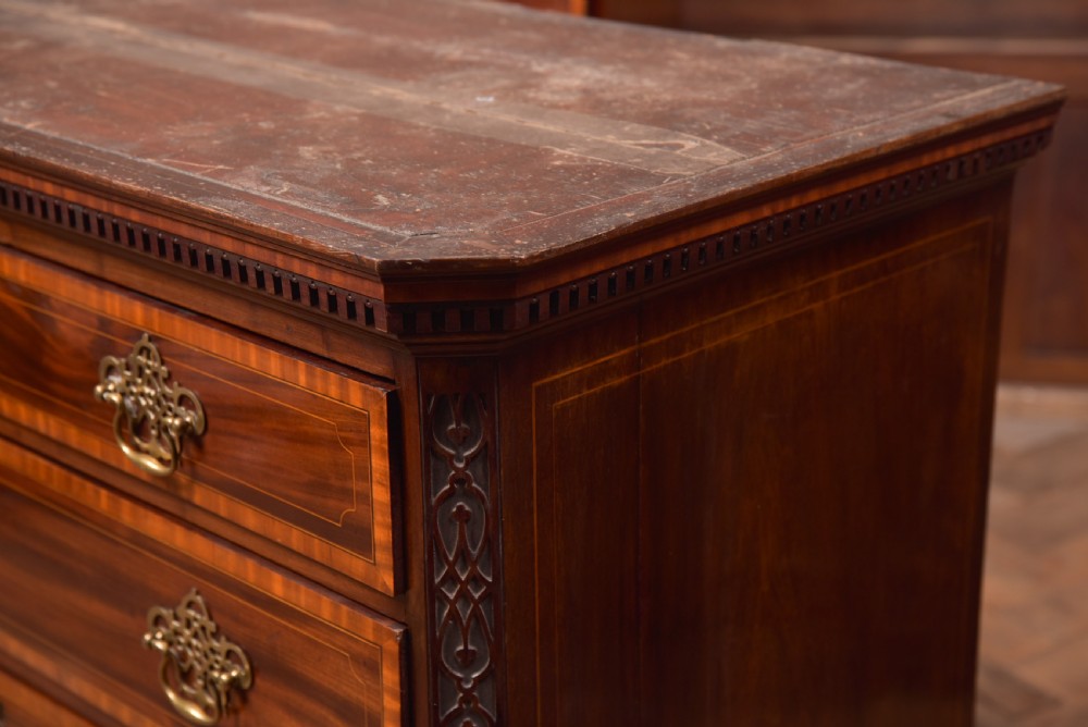 A tall Georgian mahogany chest on chest featuring inlaid drawer borders, brass handles, dentil cornice detail, and bracket feet. View XX
