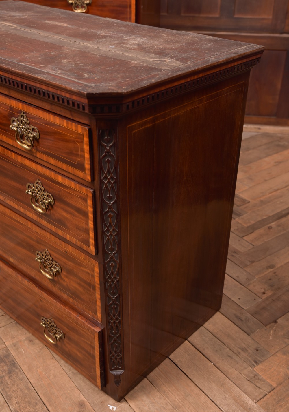 A tall Georgian mahogany chest on chest featuring inlaid drawer borders, brass handles, dentil cornice detail, and bracket feet. View XXI