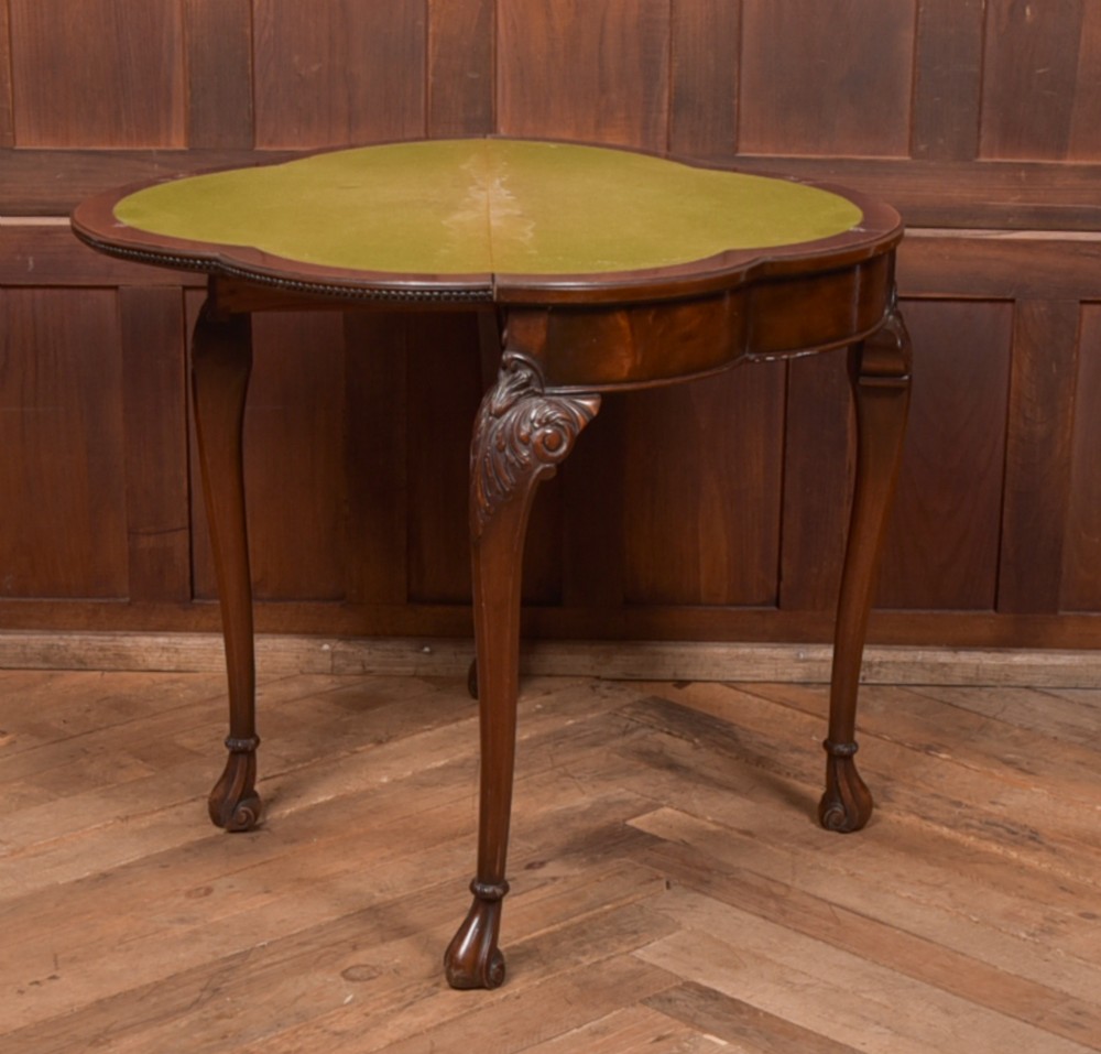 An Edwardian mahogany demi-lune card table featuring carved cabriole legs and a polished fold-over top. View VIII