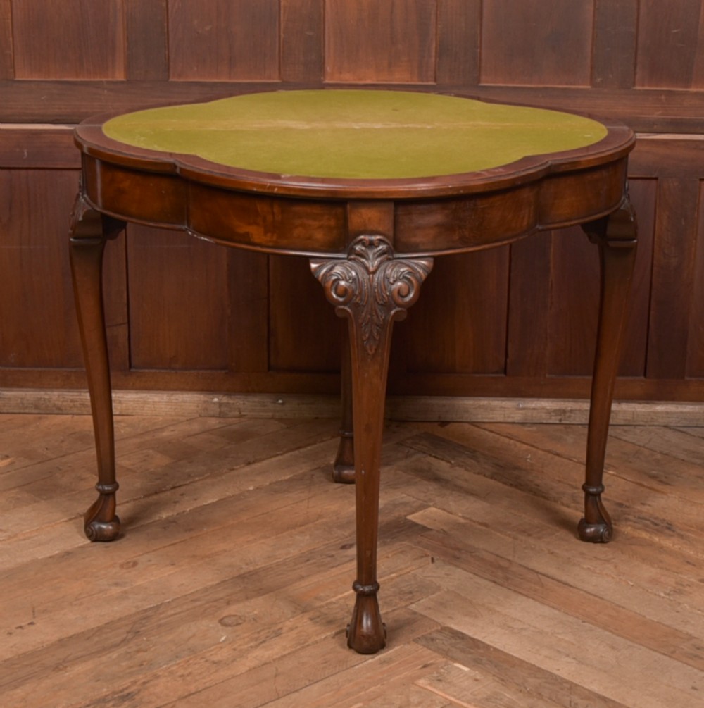An Edwardian mahogany demi-lune card table featuring carved cabriole legs and a polished fold-over top. View XI