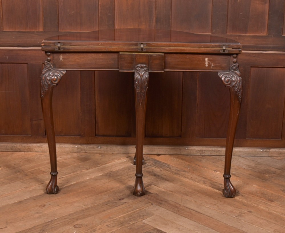 An Edwardian mahogany demi-lune card table featuring carved cabriole legs and a polished fold-over top. View XIII
