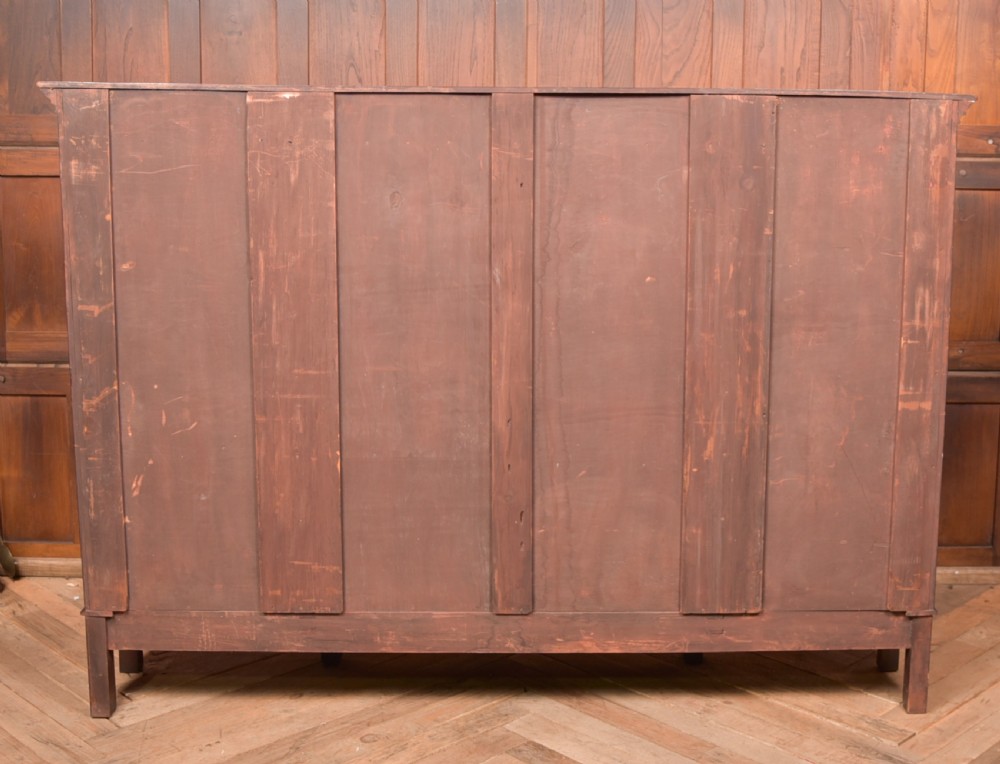 A large mahogany Chinese Chippendale style breakout bookcase featuring four glazed doors with lattice astragal glazing and dentil moulding along the top. View XXII