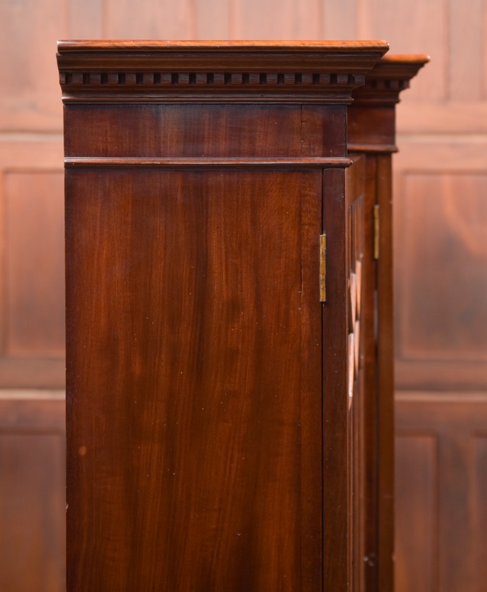 A large mahogany Chinese Chippendale style breakout bookcase featuring four glazed doors with lattice astragal glazing and dentil moulding along the top. View XXIV