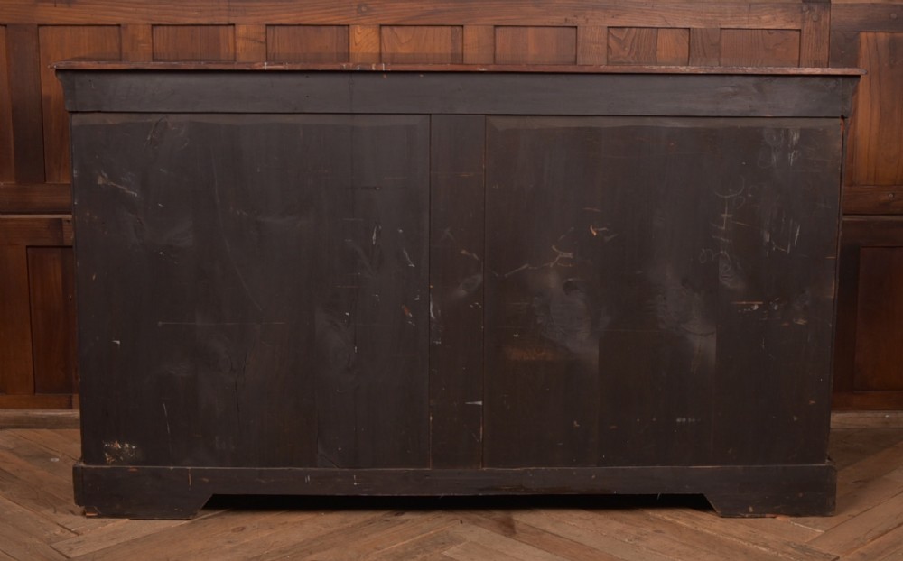 A Victorian ebonised breakfront credenza featuring glazed side doors, gilt incised urn motifs, and cast decorative mounts. View XIV