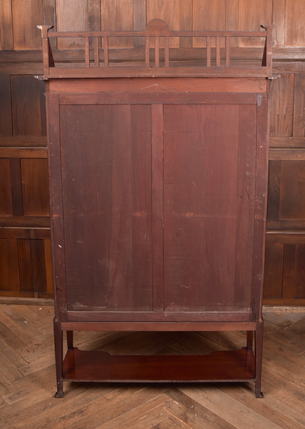 An Art Nouveau mahogany display cabinet featuring stylised floral marquetry inlays, glazed doors, an open upper gallery, and a lower shelf. View VIII