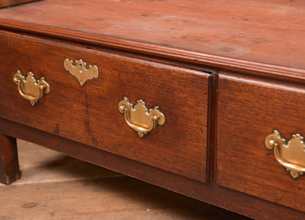 A Georgian mahogany mule chest featuring a hinged top lid above two lower drawers fitted with brass handles and keyhole escutcheons. View III
