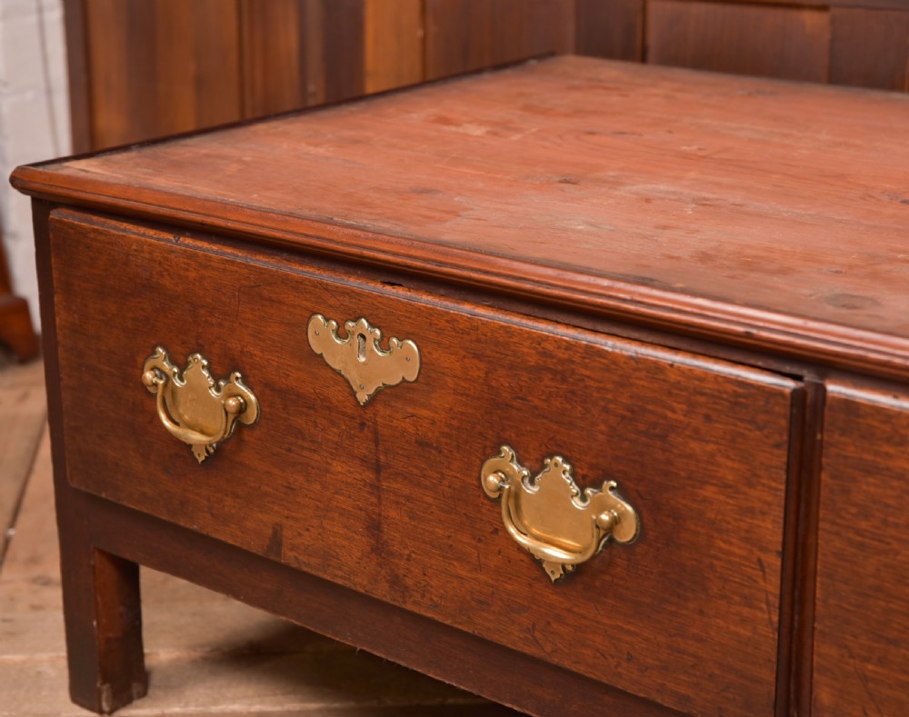 A Georgian mahogany mule chest featuring a hinged top lid above two lower drawers fitted with brass handles and keyhole escutcheons. View V
