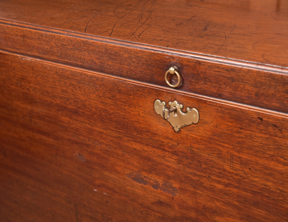 A Georgian mahogany mule chest featuring a hinged top lid above two lower drawers fitted with brass handles and keyhole escutcheons. View VII