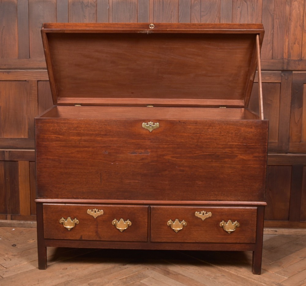 A Georgian mahogany mule chest featuring a hinged top lid above two lower drawers fitted with brass handles and keyhole escutcheons. View VIII