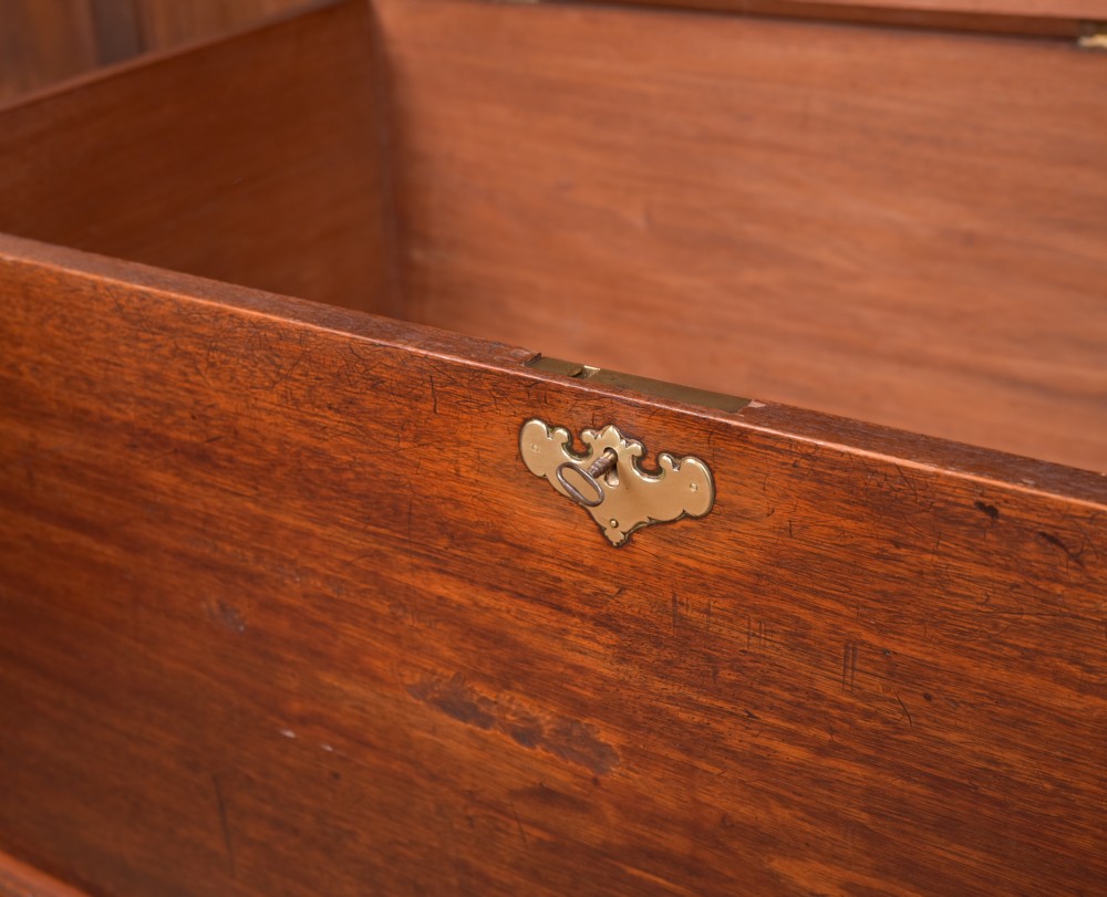 A Georgian mahogany mule chest featuring a hinged top lid above two lower drawers fitted with brass handles and keyhole escutcheons. View XI