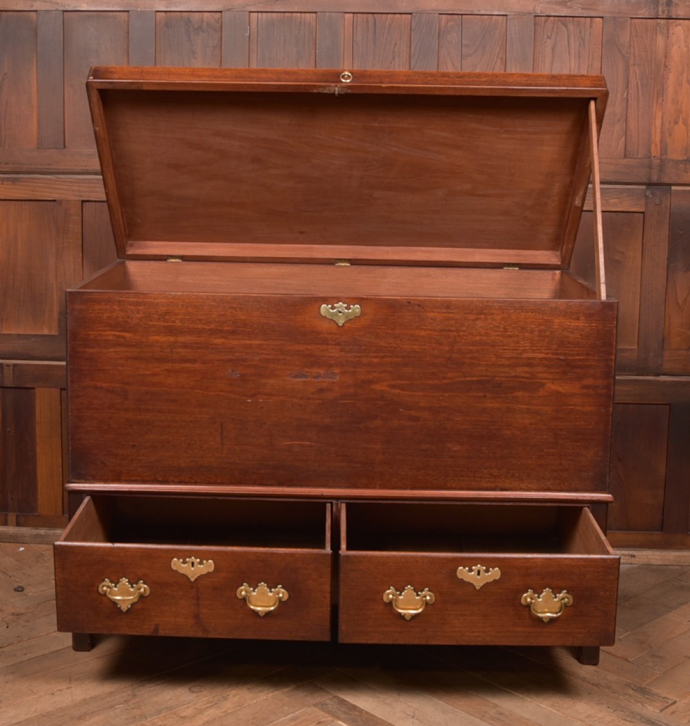 A Georgian mahogany mule chest featuring a hinged top lid above two lower drawers fitted with brass handles and keyhole escutcheons. View XII