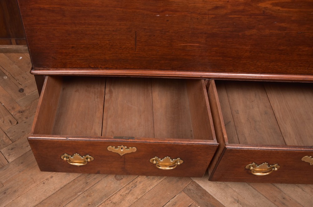 A Georgian mahogany mule chest featuring a hinged top lid above two lower drawers fitted with brass handles and keyhole escutcheons. View XIII