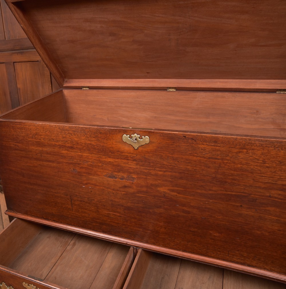 A Georgian mahogany mule chest featuring a hinged top lid above two lower drawers fitted with brass handles and keyhole escutcheons. View XV