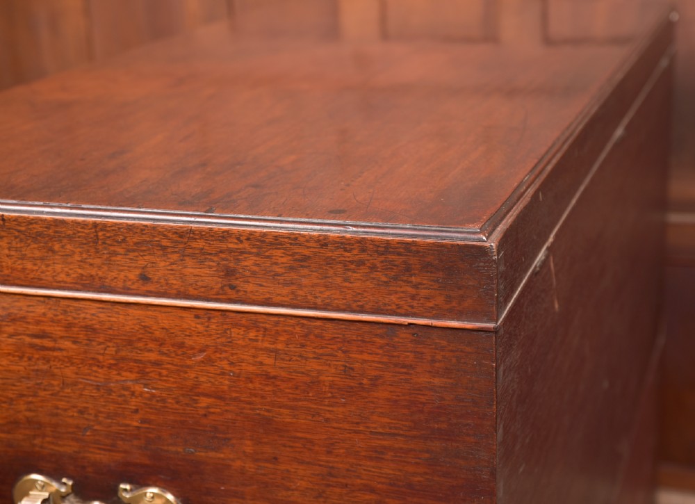 A Georgian mahogany mule chest featuring a hinged top lid above two lower drawers fitted with brass handles and keyhole escutcheons. View XXII