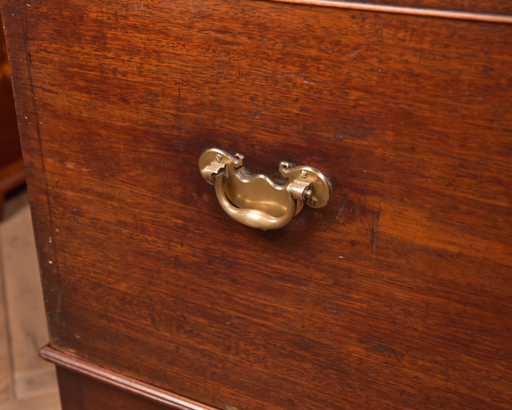 A Georgian mahogany mule chest featuring a hinged top lid above two lower drawers fitted with brass handles and keyhole escutcheons. View XXV