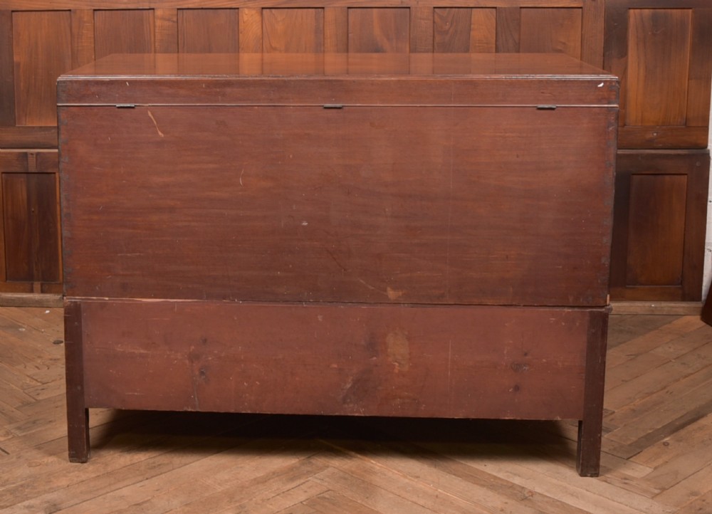A Georgian mahogany mule chest featuring a hinged top lid above two lower drawers fitted with brass handles and keyhole escutcheons. View XXVI