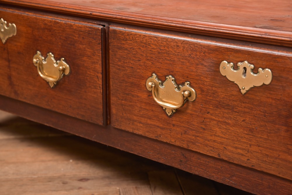 A Georgian mahogany mule chest featuring a hinged top lid above two lower drawers fitted with brass handles and keyhole escutcheons. View XXVIII