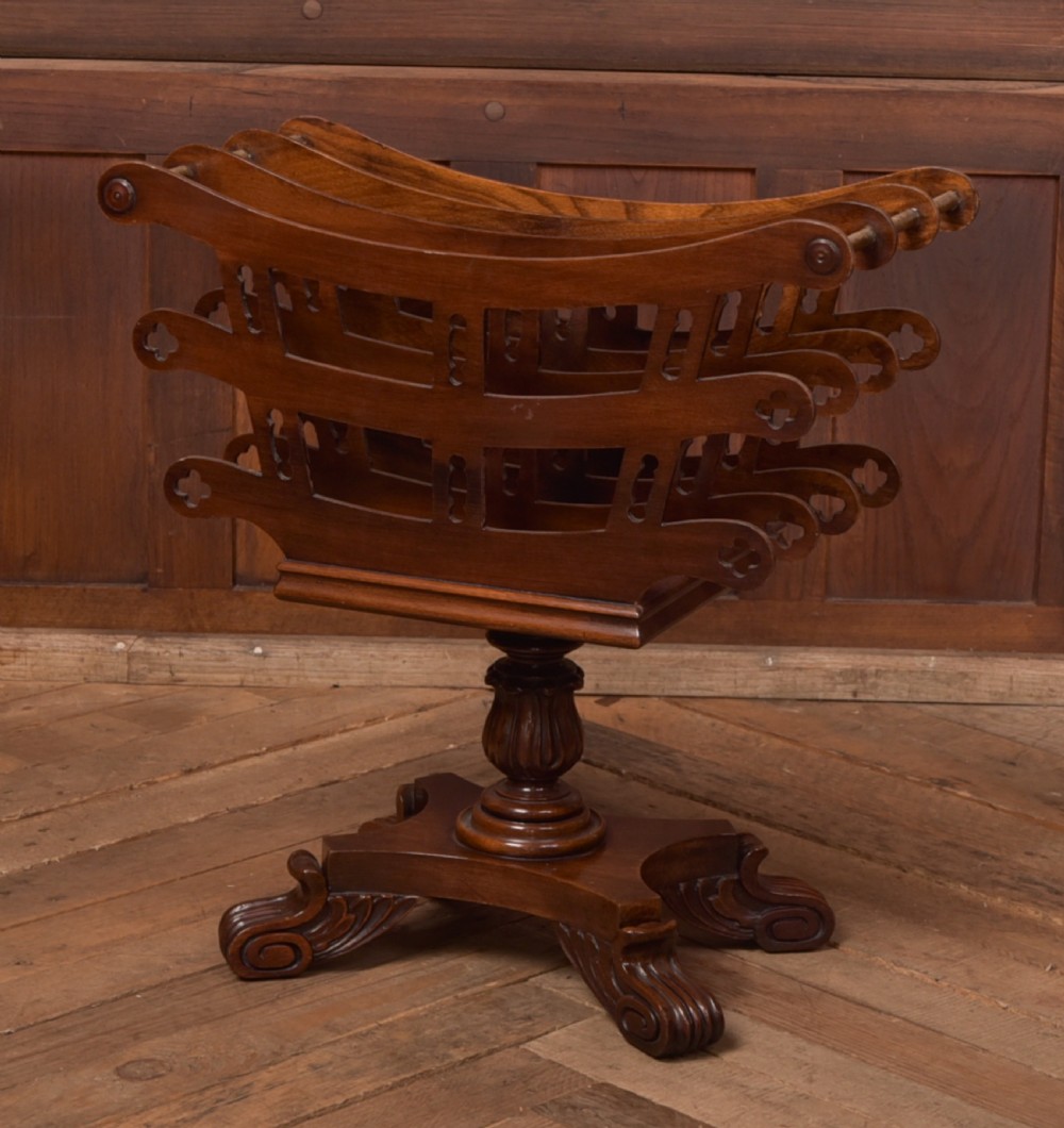 Victorian mahogany sheet music rack featuring pierced fretwork sides, divided compartments, a turned pedestal column, and carved scroll feet. View II