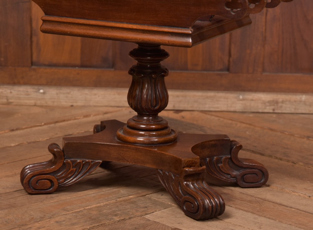 Victorian mahogany sheet music rack featuring pierced fretwork sides, divided compartments, a turned pedestal column, and carved scroll feet. View III