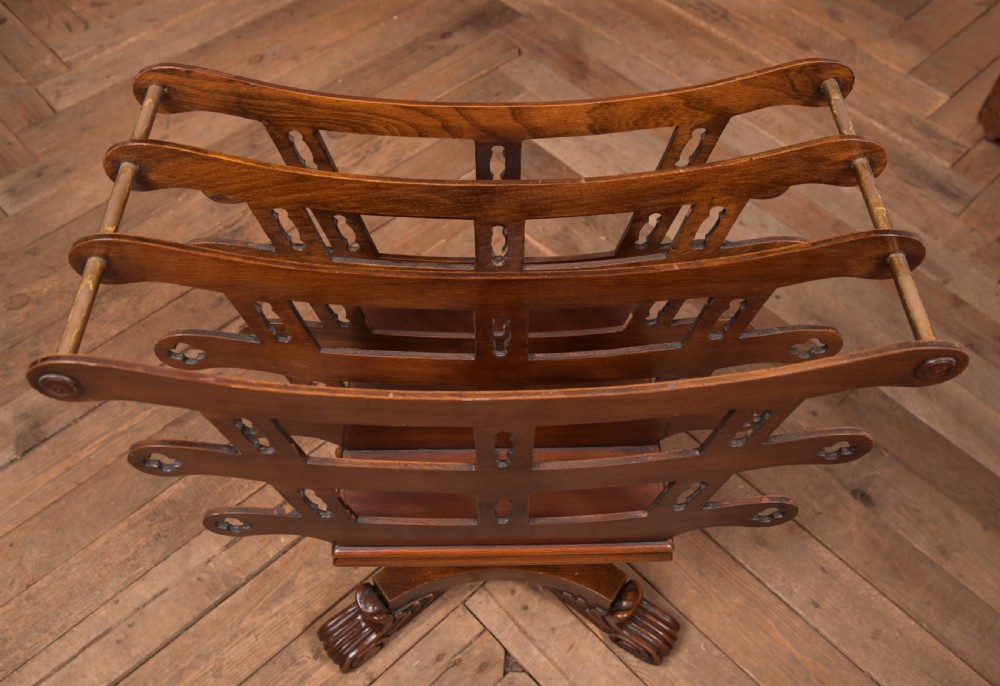 Victorian mahogany sheet music rack featuring pierced fretwork sides, divided compartments, a turned pedestal column, and carved scroll feet. View VII