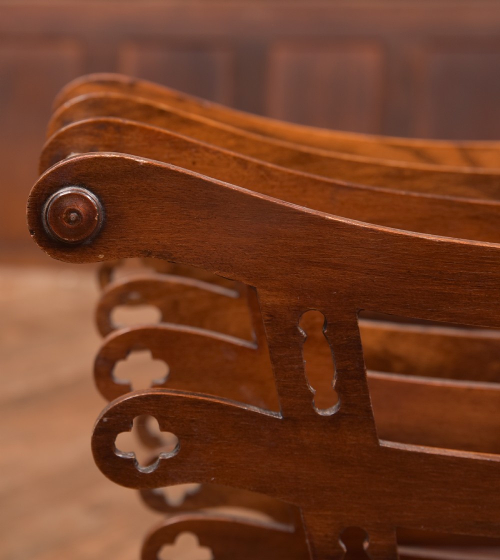 Victorian mahogany sheet music rack featuring pierced fretwork sides, divided compartments, a turned pedestal column, and carved scroll feet. View IX