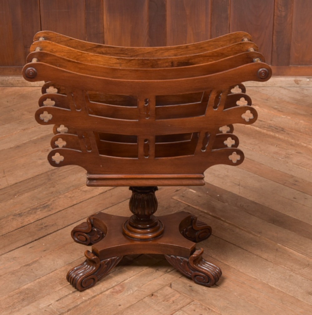 Victorian mahogany sheet music rack featuring pierced fretwork sides, divided compartments, a turned pedestal column, and carved scroll feet. View XIV