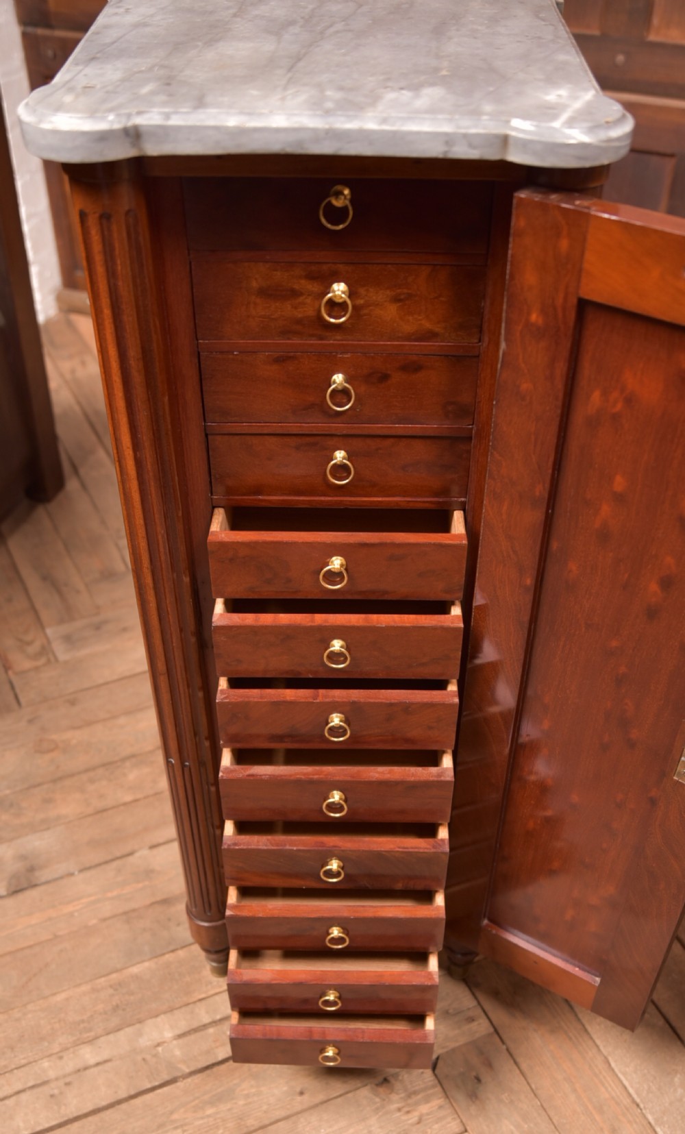 A tall Victorian mahogany cabinet featuring a single panelled door, fluted corner columns, a brass escutcheon, and a white marble top. View VIII