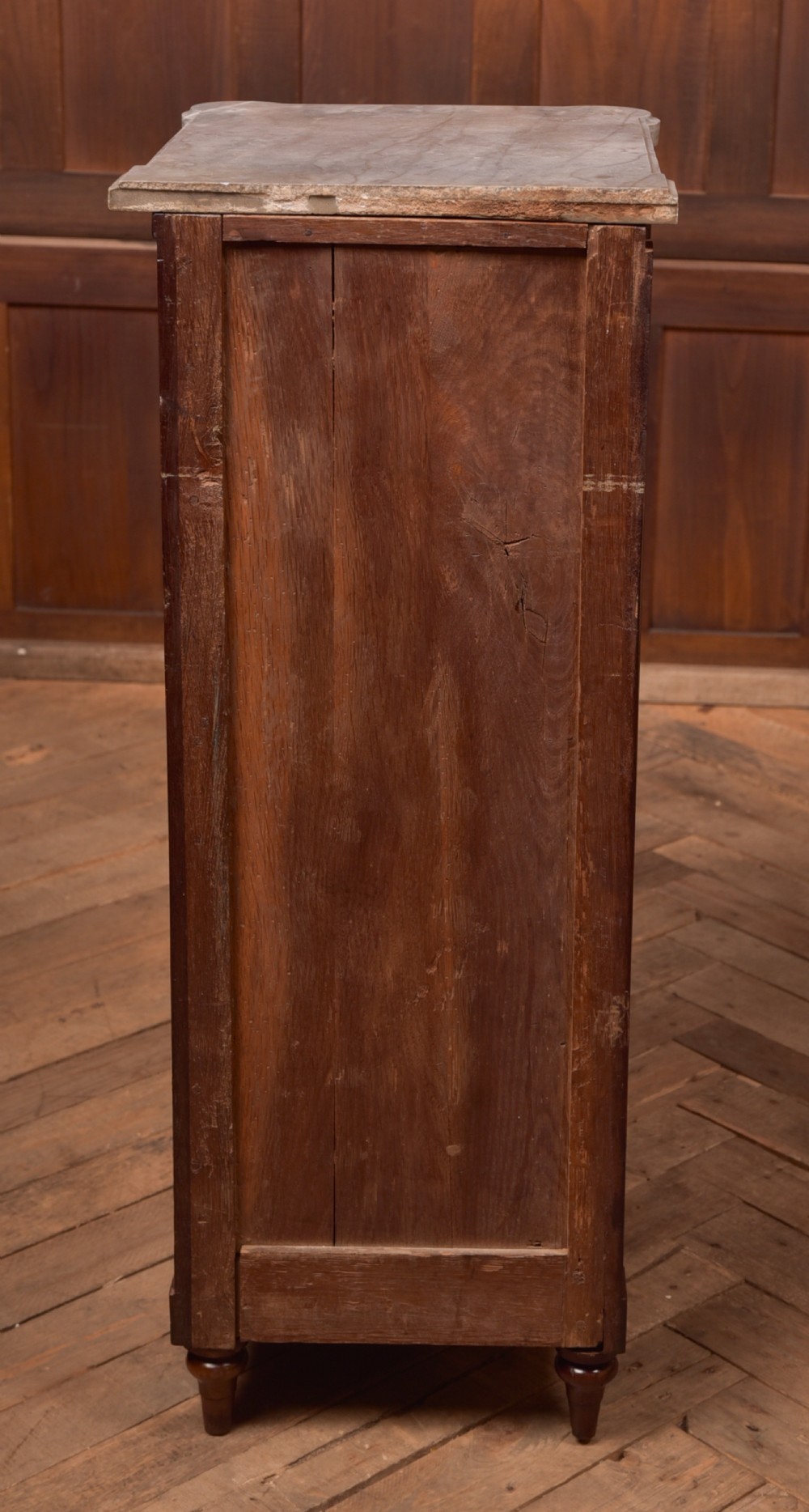 A tall Victorian mahogany cabinet featuring a single panelled door, fluted corner columns, a brass escutcheon, and a white marble top. View XV