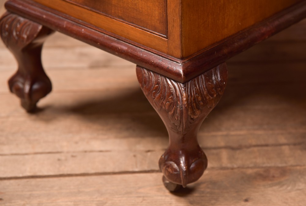 An Edwardian mahogany kneehole writing desk featuring a leather inset top, nine drawers with brass swan neck handles, and carved cabriole legs on ball and claw feet. View IX
