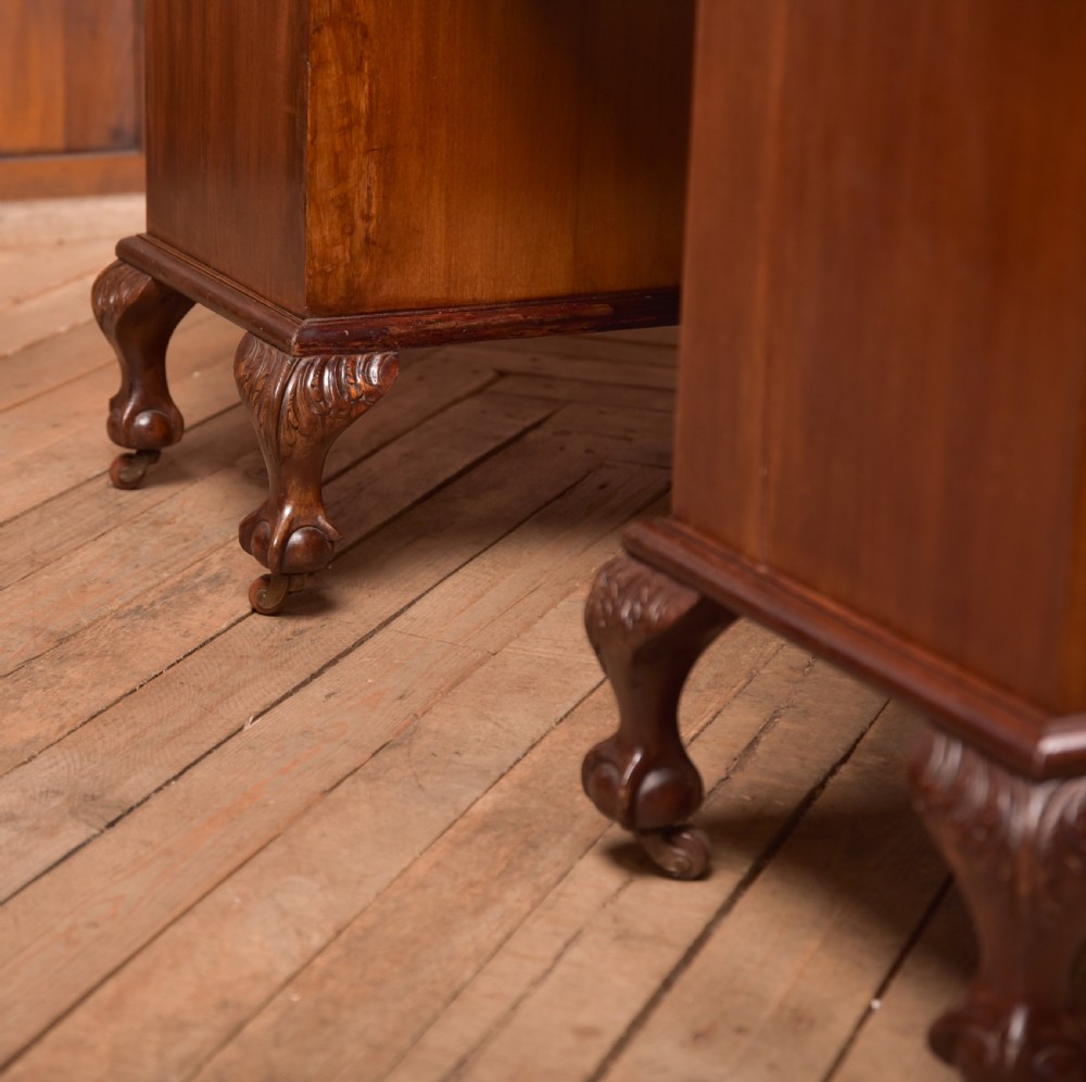An Edwardian mahogany kneehole writing desk featuring a leather inset top, nine drawers with brass swan neck handles, and carved cabriole legs on ball and claw feet. View XXIII