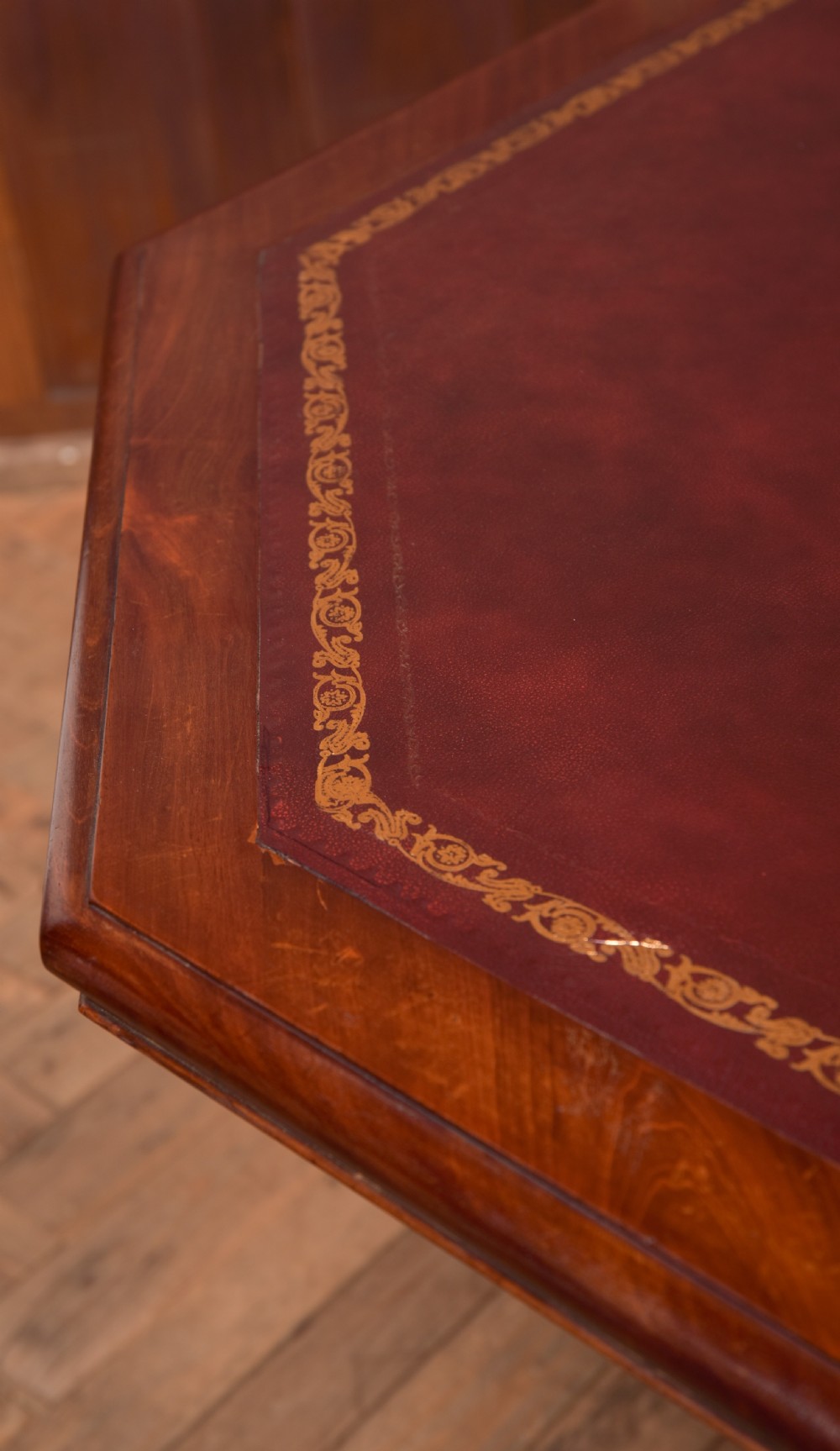 A Victorian octagonal mahogany centre table with a brown leather-inset top, four turned support columns, and a quadruped base with scroll feet. View VI