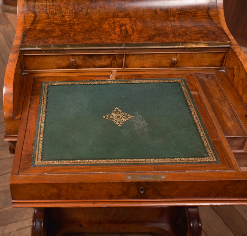 A Victorian burr walnut piano top Davenport desk featuring a carved fretwork gallery, sloped writing lid, scroll front supports, and side-opening drawers. View XI