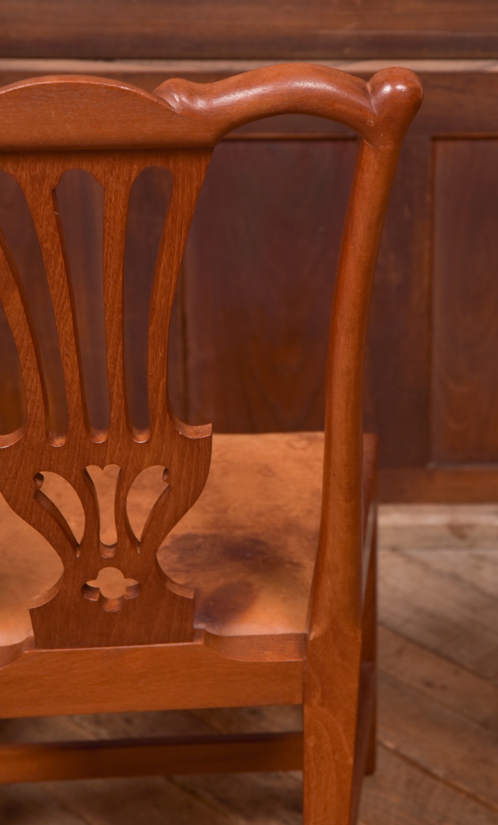 A matching pair of warm brown walnut side chairs with pierced vasiform splats, shaped crest rails, and upholstered drop-in seats supported by square legs with H-stretchers. View VI