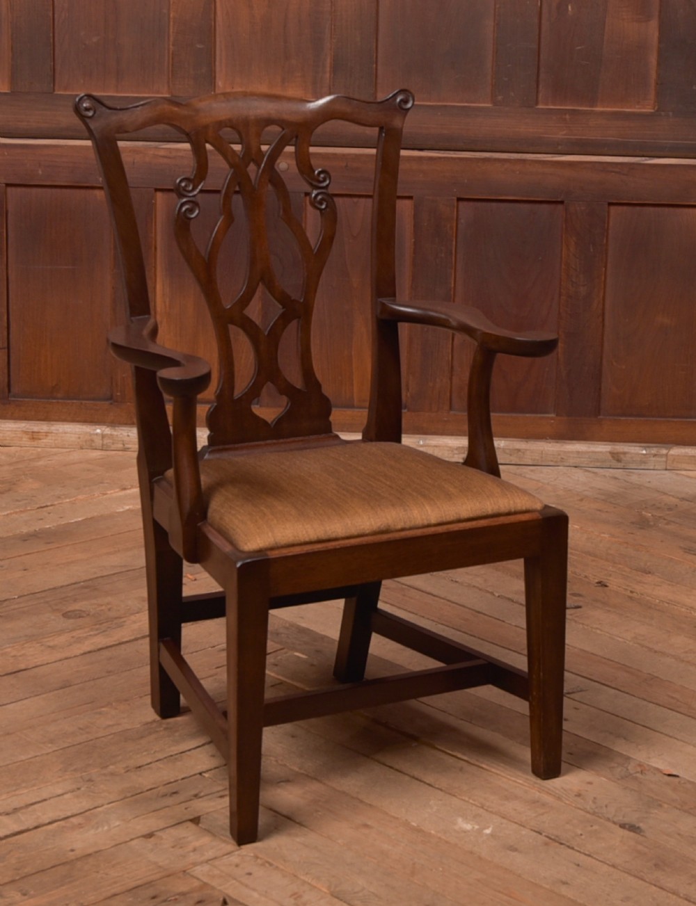 A dark hardwood open armchair featuring a pierced carved back splat, curved armrests, and a textured brown upholstered drop-in seat. View II
