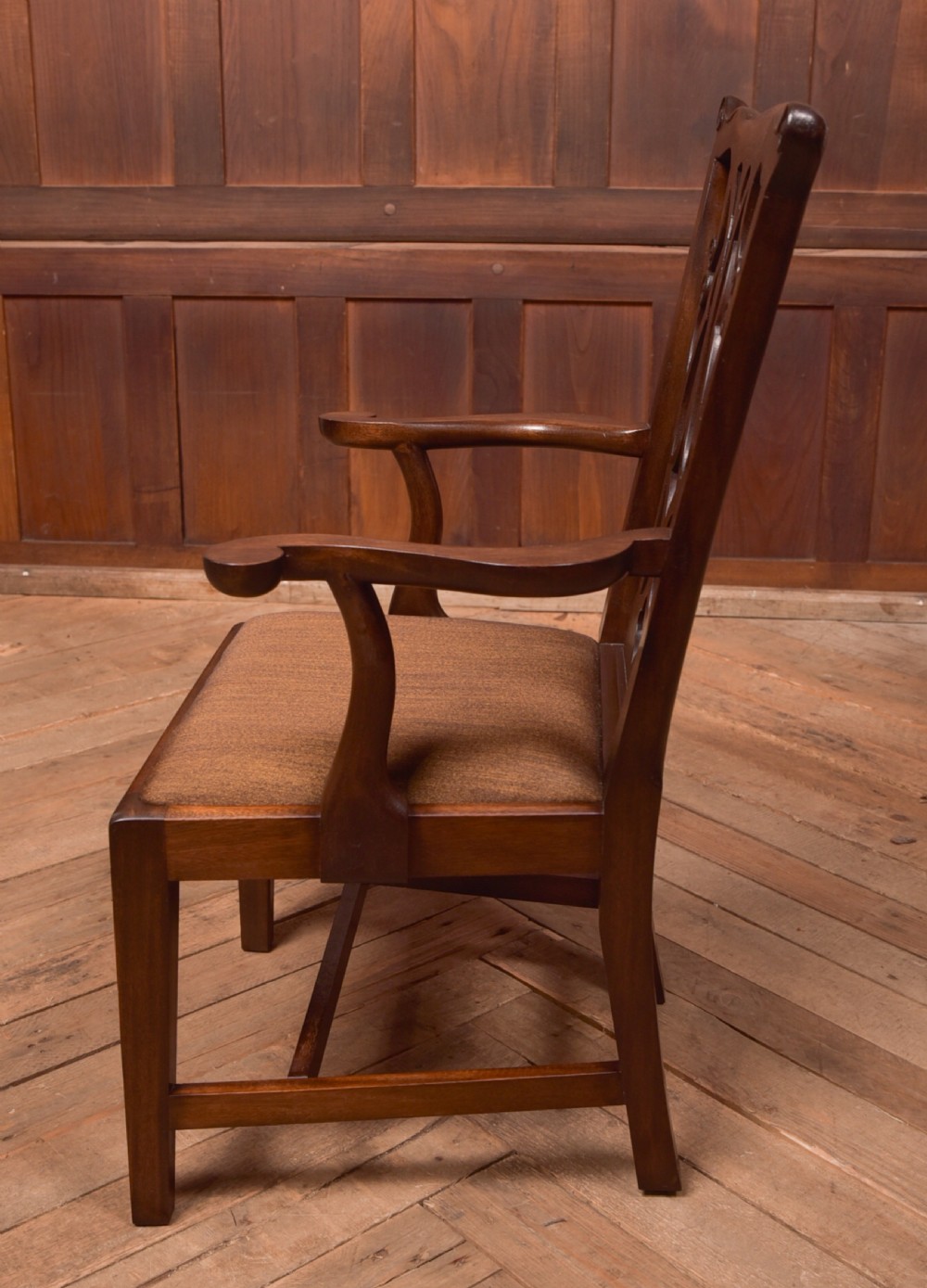A dark hardwood open armchair featuring a pierced carved back splat, curved armrests, and a textured brown upholstered drop-in seat. View IX