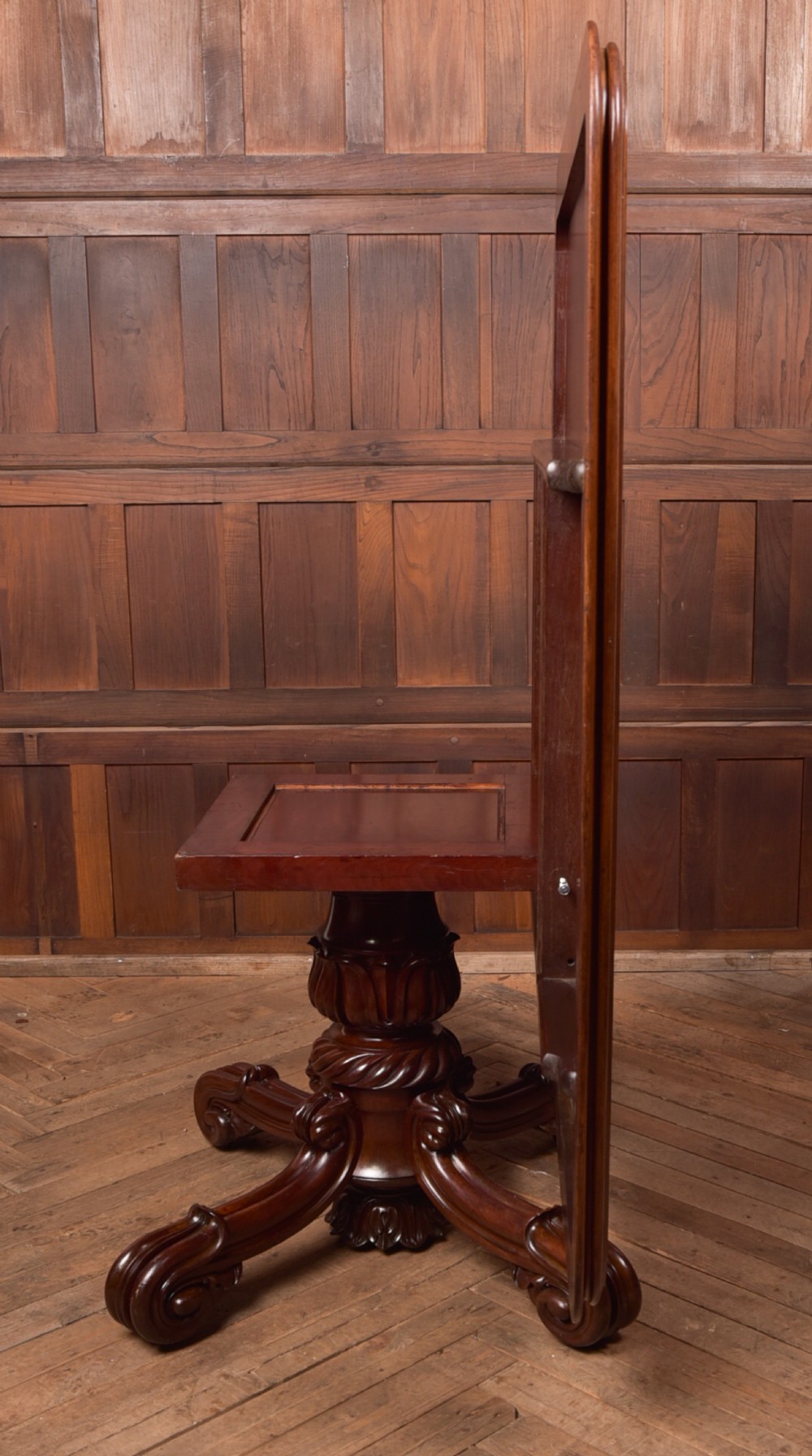 A Victorian mahogany tilt-top table featuring a polished rectangular top with rounded corners set upon a carved pedestal stem with quadruped scrolled legs. View XIII